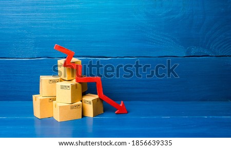 Cardboard boxes and red down arrow. Fall in sales and production of goods, low volume of delivery traffic and freight. Economic recession, skepticism and business pessimism. Low import export. Crisis