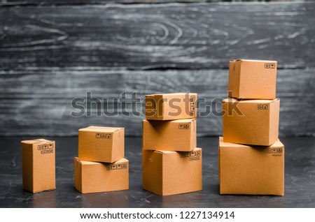 Cardboard boxes are stacked incrementally. Sales growth and increase in exports of goods and services. Warehouse products and equipment. The concept of packing goods, sending orders to customers.