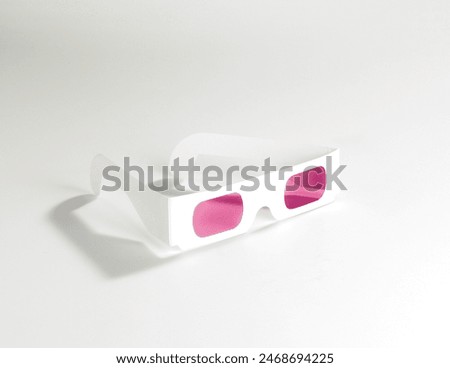Cardboard eclipse viewer. Eclipse glasses with pink lenses. 3D glasses isolated in cardboard on white background. Looking through rose-tinted glasses.