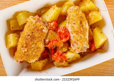 Cardboard Food Tray With Baked Potatoes, Tomatoes And Breaded Fish Rolls Prepared For A Take Away Lunch