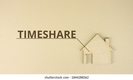 Cardboard home icon with TIMESHARE text on the table