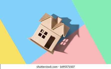 Cardboard house with drop shadow overhead view