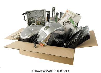 In A Cardboard Industry  Box  Are Old Faulty Broken Audio And Video Electronics. Devices Are Prepared For Recycling On Garbage. Isolated With Patch. All Logos And Trademarks Is Removed