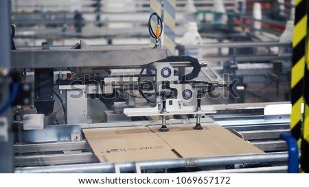 Cardboard package box packing machine. Clip. Box forming production line