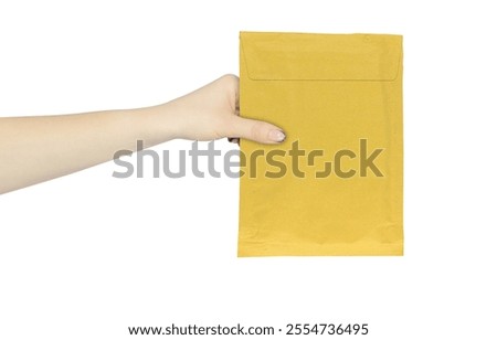 Cardboard package for document delivery, soft envelope, cardboard package, packaging paper letter in hand, outstretched hand with packaging paper letter isolated from background