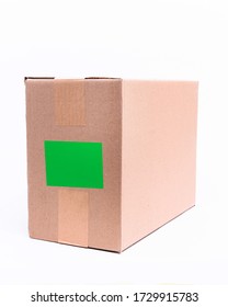 Cardboard package parcel, mockup with a green screen by a blank sticker. - Shutterstock ID 1729915783
