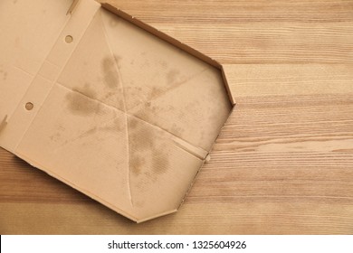 Cardboard Pizza Box On Wooden Background, Top View With Space For Text