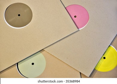 Cardboard Sleeve Vinyl Music Records With Colorful Blank Labels.