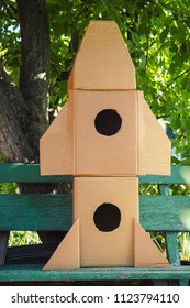 Cardboard Space Rocket On Bench. Concept Image.