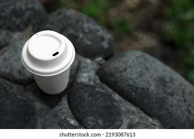 Cardboard Takeaway Coffee Cup With Lid On Stones Outdoors, Above View. Space For Text