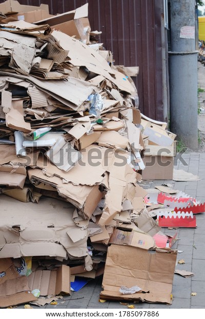 Cardboard and\
waste paper is collected and packaged for recycling. Pile of\
cardboard to be recycled. Urban\
Recycling.