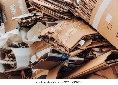 Cardboard waste pile stacked on a landfill. Recycled paper or reuse concept