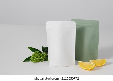 Cardboards packaging for tea, flowers and lemons on a white background. Blank tea packaging mockup with tea to demonstrate your branding design. High quality photo