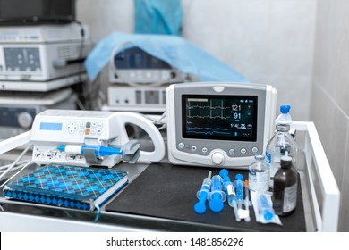 Cardiac monitor and syringe at operating table. Pet surgery.