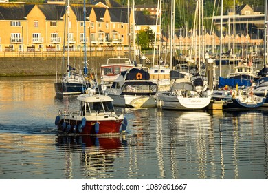 Cardiff Bay, Wales - Ma 2018: A Small Fishing Boat Making It's From Penarth Harbour Across Cardiff Bay In Early Morning Light For A Day's Fishing In The Bristol Channel