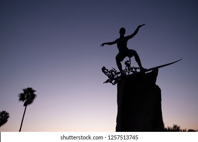 Cardiff by the Sea, California / USA 12/11/2018. The "Cardiff Kook" statue stands guard over Cardiff state beach at sunset in San Diego California. Cardiff is a world class surfing destination.
