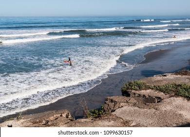 CARDIFF, CALIFORNIA/USA - APRIL 14, 2018:  Male surfers at San Elijo State Beach in Cardiff, California, located in San Diego County.