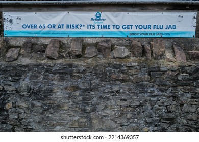 Cardiff, UK - 10.15.2022: Advertising Banner Encouraging The Over-65's And People At Risk To Book Their Flu Vaccination Before The Winter Flu Season