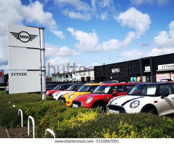 Cardiff, UK: August 19, 2019: Mini Car Dealership with\
new and used cars on sale. Mini is a British automotive marque,\
owned by BMW since 2000, and used by them for a popular range of\
small cars. 