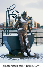 Cardiff, UK, January 1, 2000. From Pit To Port Sculpture Which Celebrates Welsh Coal Miners In Cardiff Bay With Snow, Wales