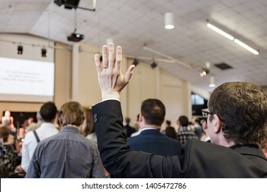 Cardiff, UK. July 2018. A Man Raises His Hand In Worship In A Christian Church Service.