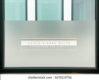 CARDIFF, WALES - MARCH 2020: Close up view of a sign for the Marco Pierre White restaurant etched on a glass window panel in the Hotel Indigo in Cardiff city centre.