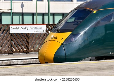 Cardiff, Wales - March 2022: Class 800 high speed train operated by Great Western railway at one of the platforms of Cardiff Central railway station. In the background is a station name sign.