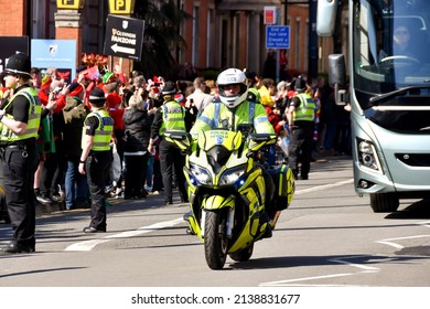 Cardiff, Wales - March 2022: Police motorcycle outrider escorting a team bus in Cardiff city centre