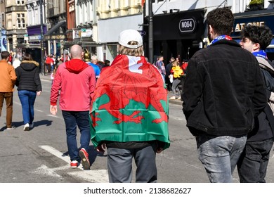 Cardiff, Wales - March 2022: Rugby Fan With A Welsh Flag Around His Shoulders In Cardiff City Centre