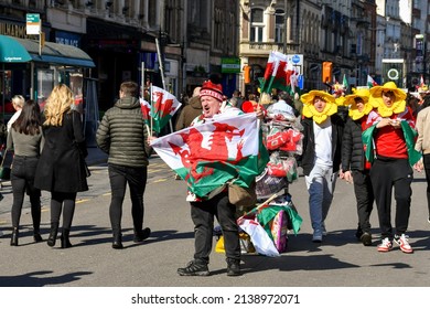 Cardiff, Wales - March 2022: Street trader selling Welsh flags ro rugby fans in Cardiff city centre on match day
