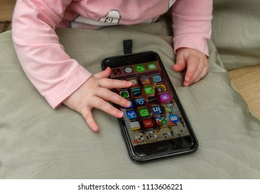 CARDIFF, WALES - MAY 2018: A Baby Playing With An IPhone