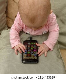 CARDIFF, WALES - MAY 2018: A Baby With Her Hands On An IPhone