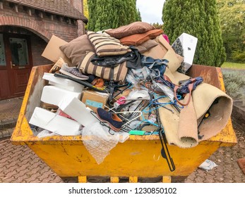 CARDIFF, WALES - NOVEMBER 2018: Close Up View Of A Large Heavy Skip Filled With Rubbish From A House Clearance.