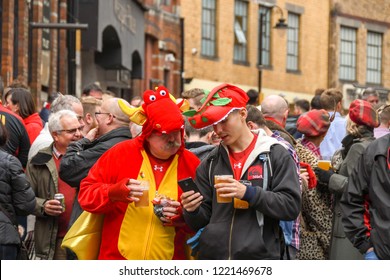 CARDIFF, WALES - NOVEMBER 2018: Two Welsh Rugby Supporters Having A Drink And Talking In A Crowd Outside A Public House In Cardiff City Centre Before An International Rugby Match.