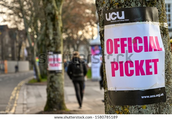 CARDIFF, WALES - NOVEMBER 2019: Sign attached to a\
tree near an official picket line outside Cardiff University. It\
marks industrial action by members of the Universities and College\
Union.