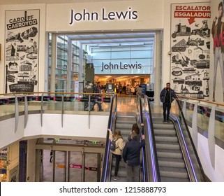 CARDIFF, WALES - OCTOBER 2018: Shoppers at the entrance to the John Lewis store in the St David's shopping centre in Cardiff city centre.
