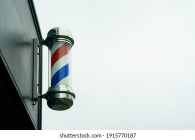 Cardiff, Wales, UK - 01.27.2020: A Classic Barbershop Pole Outside The Entrance.