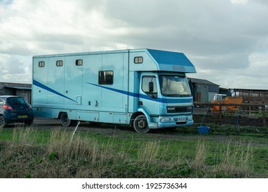 Cardiff, Wales. UK - 02.27.2021: A horse trailer, (also known as a horsebox or horse van) is parked outside a van. These are used to transport horses and ponies.