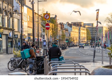 Cardiff, Wales, UK - April 12th 2021: General View Of Deliveroo Delivery Cyclists On Duke Street, This Evening.