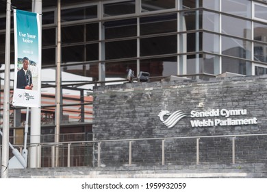 Cardiff, Wales, UK - April 21 2021: Bilingual banners outside the Senedd Cymru Welsh Parliament encouraging voters to ‘Use Your Voice’ ahead of the Senedd election on 6 May. 