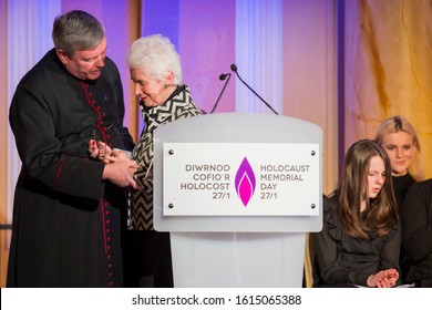 Cardiff, Wales, UK, January 27th 2017. Holocaust Survivor Eva Clarke Is Supported By Reverend Canon Stewart Lisk After Reading Her Story At The Holocaust Memorial Day Service At Cardiff City Hall.
