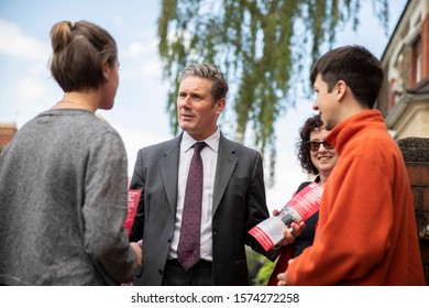 Cardiff, Wales, UK, May 20th 2019. Labour MP Keir Starmer greets young student voters during Welsh Labour campaigning for the European Elections in Roath, in the constituency of Cardiff Central.