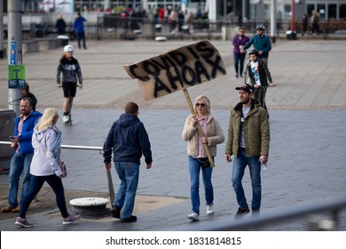 CARDIFF, WALES, UNITED KINGDOM - October 11, 2020 - A Protester Holds A Placard Reading ‘covid Is A Hoax’ During A Protest Against Coronavirus Lockdown Restrictions . 