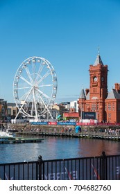 CARDIFF/UK - AUGUST 27 : Ferris Wheel and Pierhead Building in Cardiff on August 27, 2017. Unidentified people