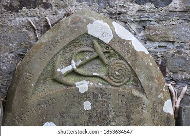 CARDIGAN, UNITED KINGDOM - Sep 15, 2020: Anchor Carved In A Grave On The Cemetery In The St Dogmaels Abbey, Cardigan, Pembrokeshire, Wales