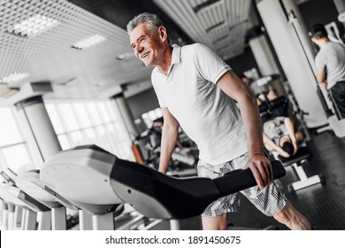 Cardio. The older man smiles and performs a cardio exercise. - Powered by Shutterstock