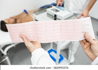 Cardiogram test, close-up of ECG report over mature male patient