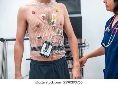 Cardiologist attaching a Ecg Holter to a patient to perform a cardiovascular stress test in the hospital