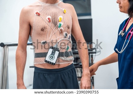 Cardiologist attaching a Ecg Holter to a patient to perform a cardiovascular stress test in the hospital