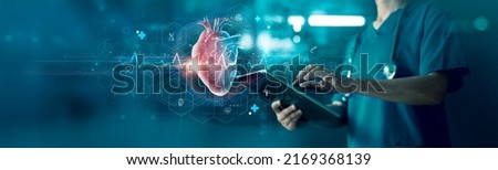 Cardiologist doctor examine heart functions and check up report electronic medical record of patient on tablet. Digital healthcare and network connection on interface, Science. Medical technology.
